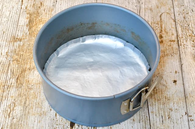 A lined deep round quick release cake tin.