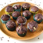 A bamboo tray of homemade triple chocolate muffins.