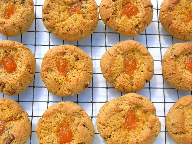 Twelve vanilla apricot buns cooling on a wire rack.