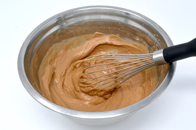Chestnut flour and water batter in mixing bowl with whisk.