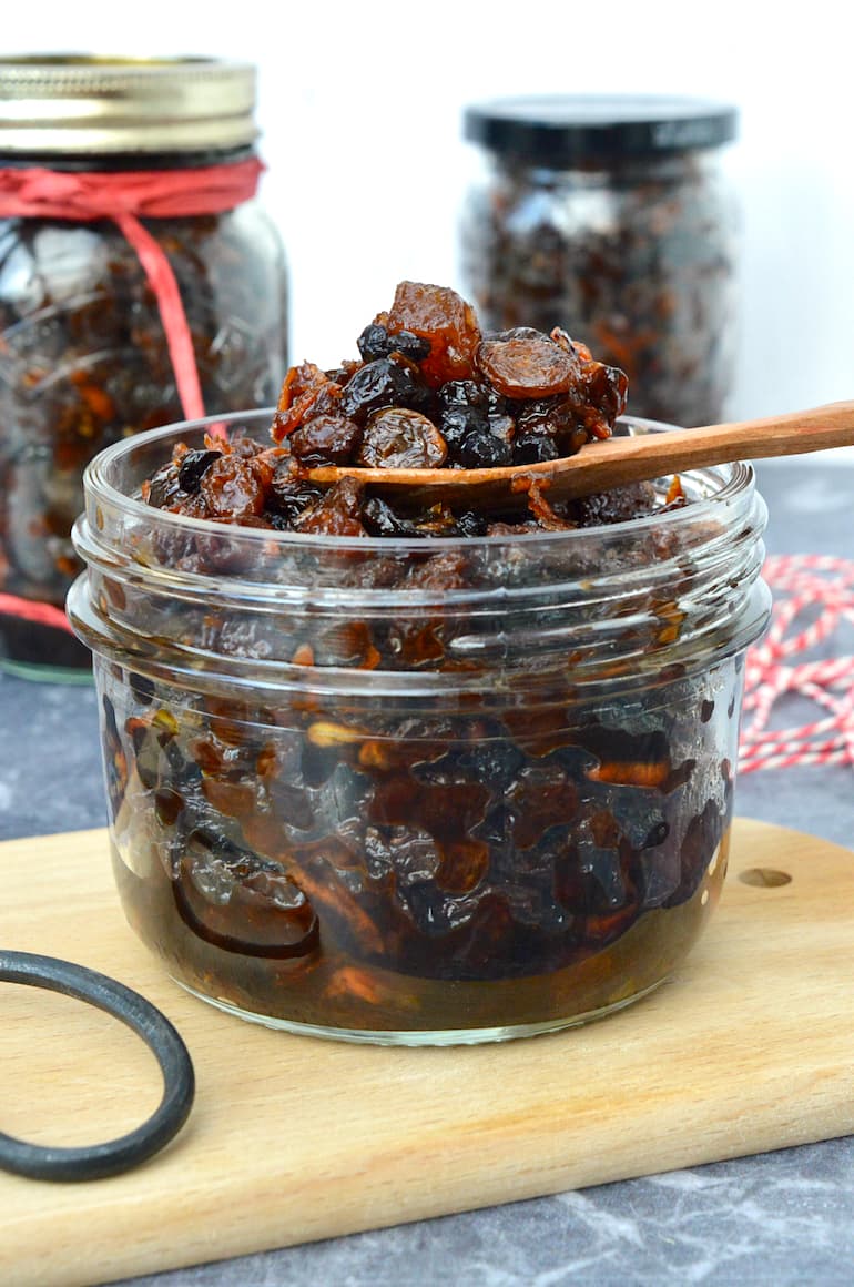 An open jar of homemade fresh fat-free mincemeat with a spoon on top.