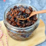 An open jar of homemade fresh fat-free mincemeat with a spoon on top.