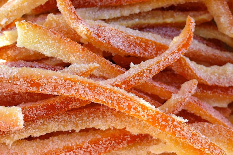 Close up of a stack of homemade candied orange peel.