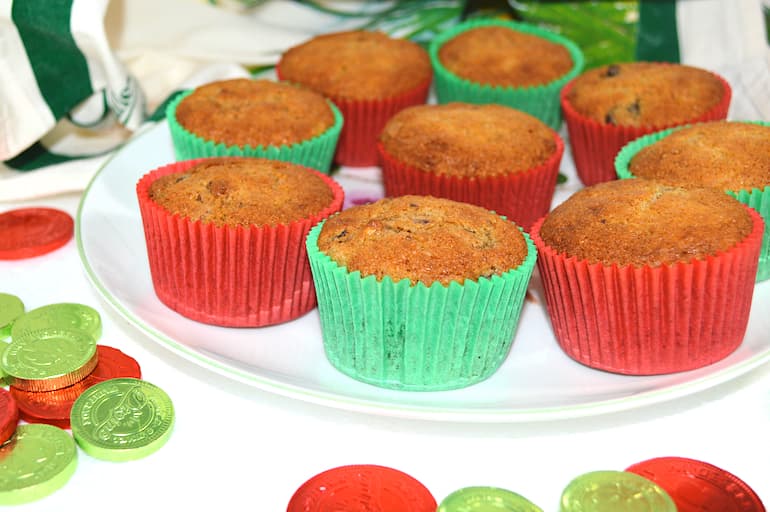 A plate of festive leftover mincemeat buns in red and green cases. Red and green chocolate coins on the side.