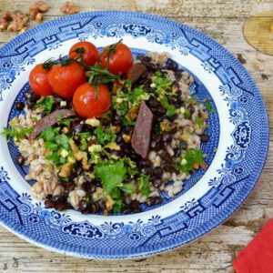 A plate of barley lentil dinner with roasted tomatoes and walnut gremolata.