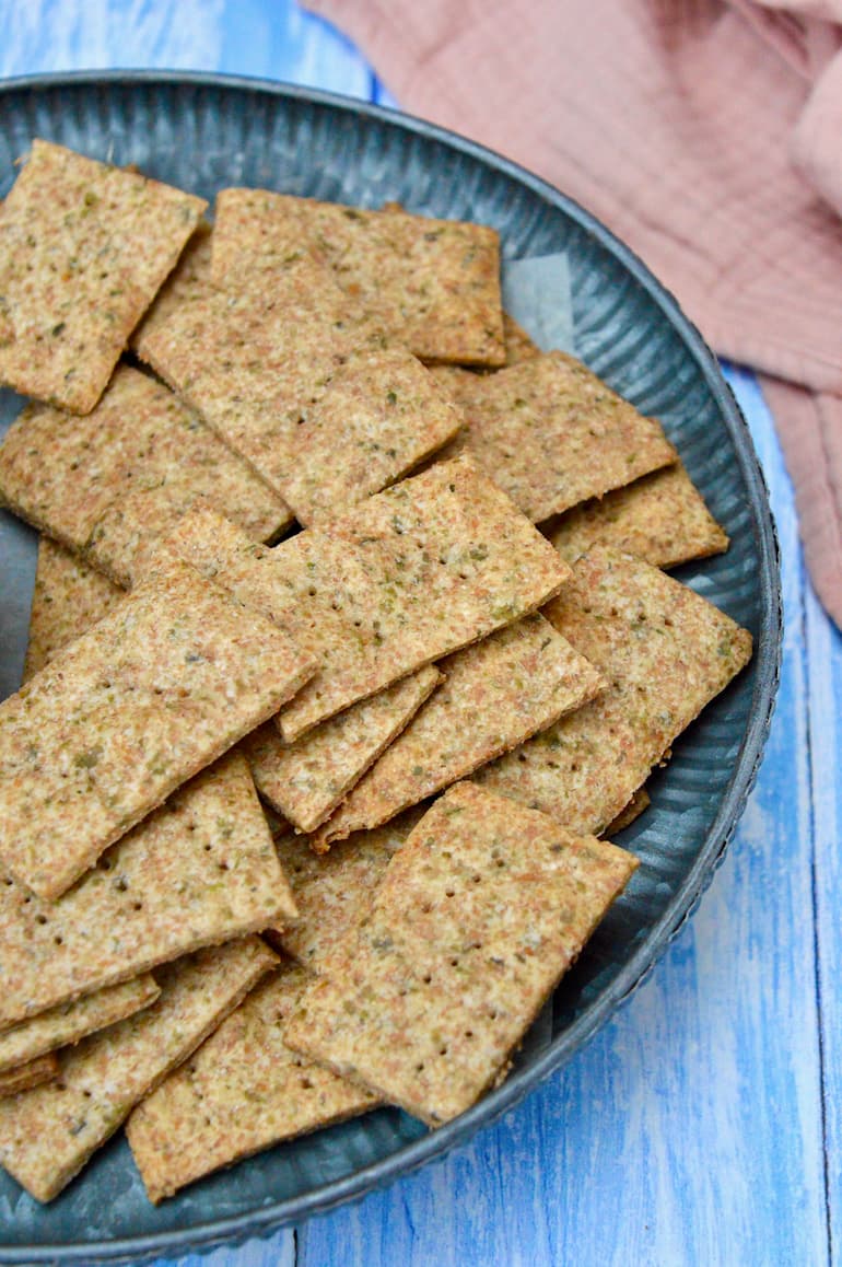 Partial view of a platter of homemade spelt and seaweed crackers.