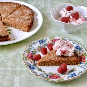 A plate of almond rye shortbread with accompanying whisky raspberry cream.