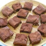 A bamboo platter of dark and white chocolate squares.