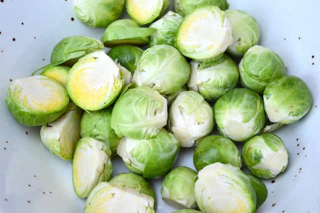 Prepared raw Brussels sprouts in a bowl.