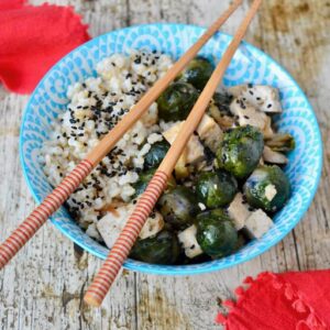 Teriyaki rice bowl with tofu, Brussels sprouts and chopsticks.