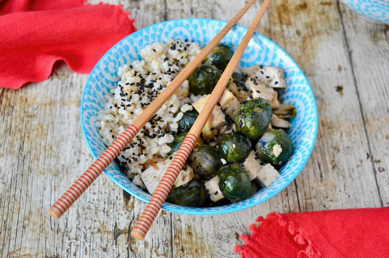 Teriyaki rice bowl with tofu, Brussels sprouts and chopsticks.