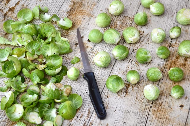 Prepared Brussels sprouts with knife and trimmings.