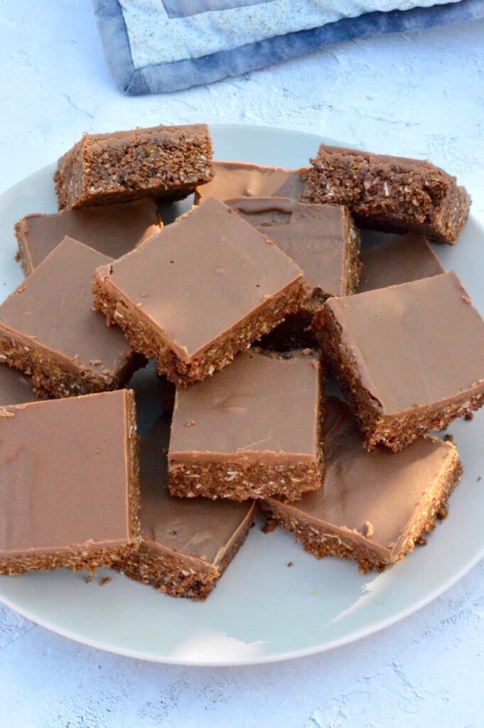 Chocolate cornflake coconut crunch bars piked on a plate.