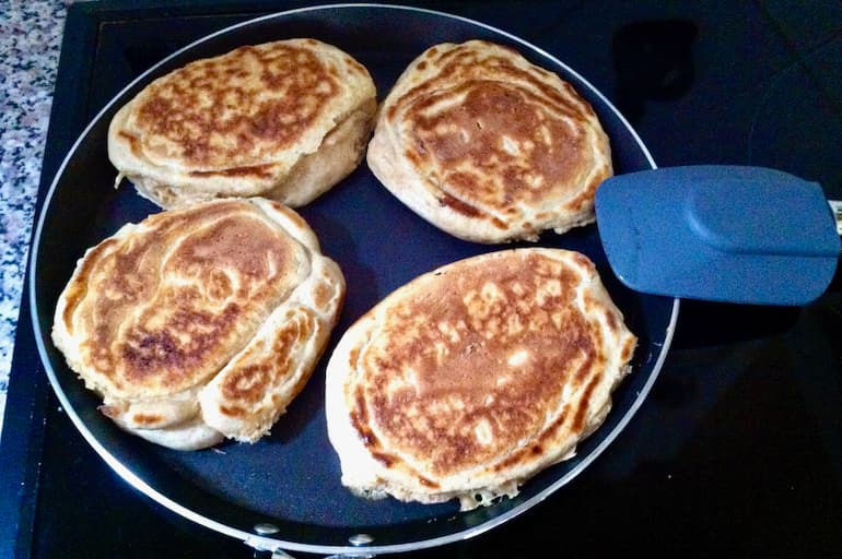 Homemade crempogau (Welsh pancakes) baking on a pan.