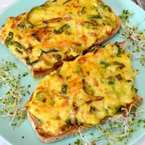 Two slices of Welsh rarebit made with leeks.