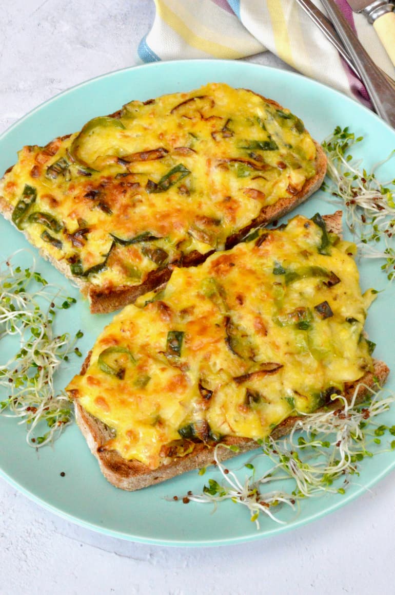 Two slices of Welsh rarebit made with leeks.