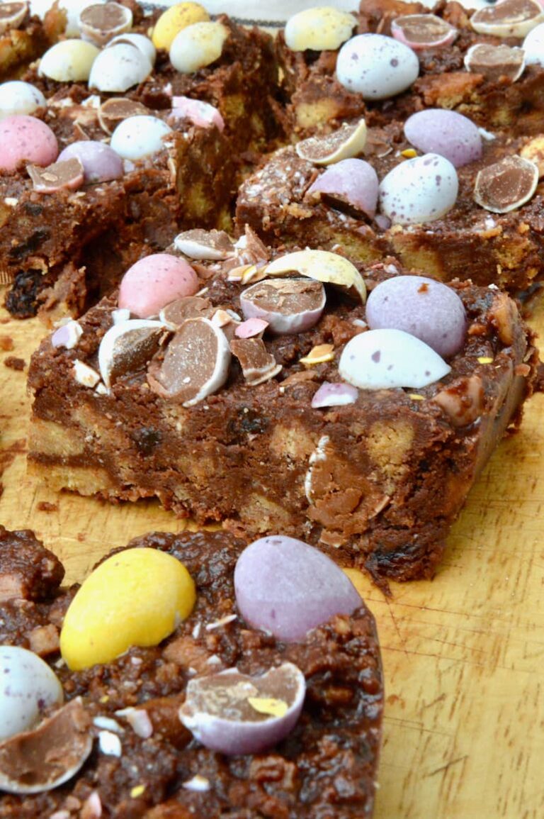 Close up of easy to make Easter tiffin bars (no-bake fridge cake) with smashed mini eggs on top.