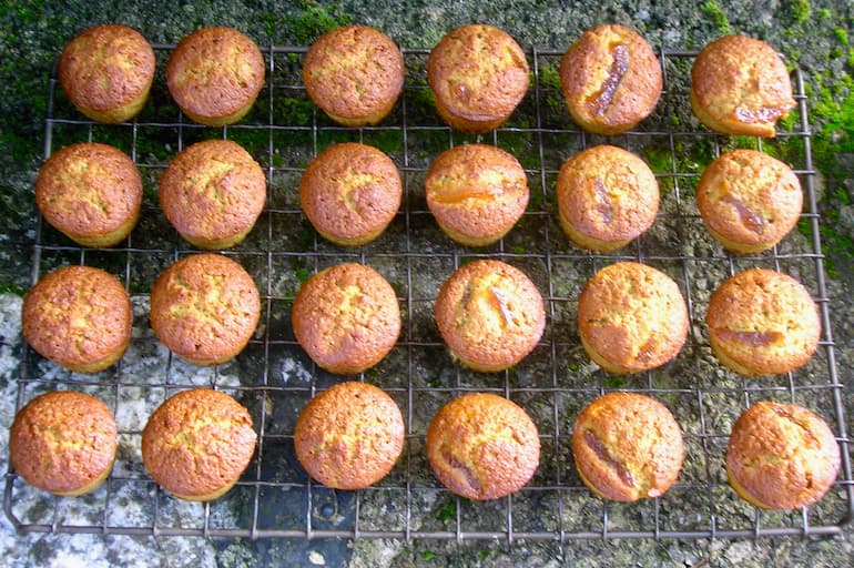 Mini matcha marmalade cakes cooling on a wire rack.