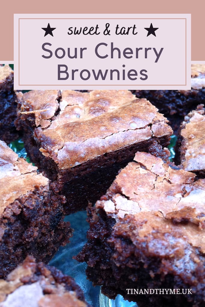 A close up of several sour cherry brownies on a plate.