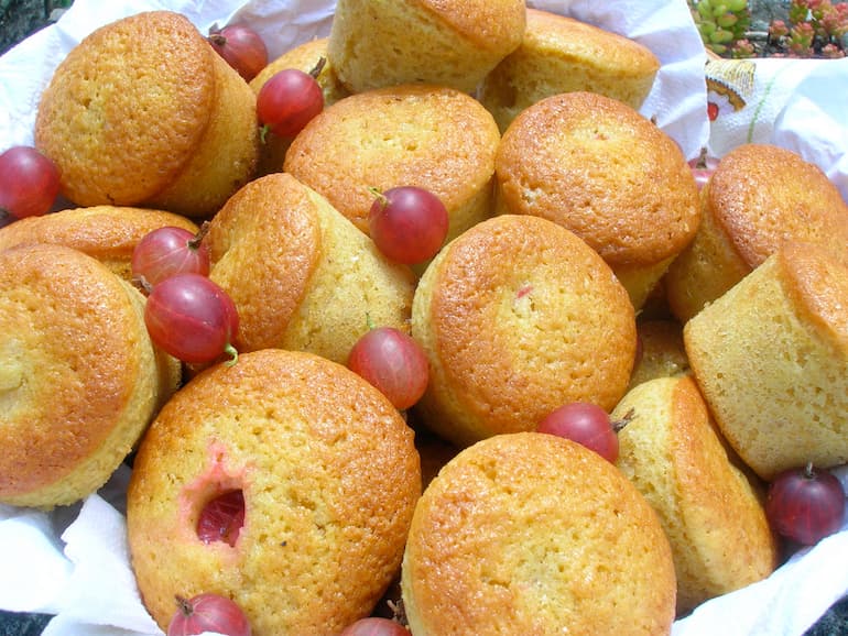 A basket of min red gooseberry cakes.