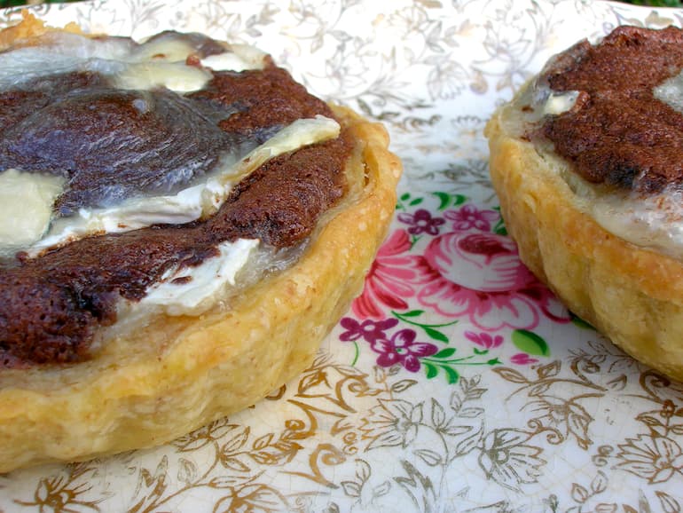 Partial view of two chocolate goat's cheese tarts.