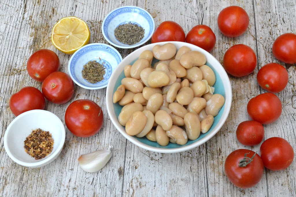 Ingredients needed to make roasted tomato dip.