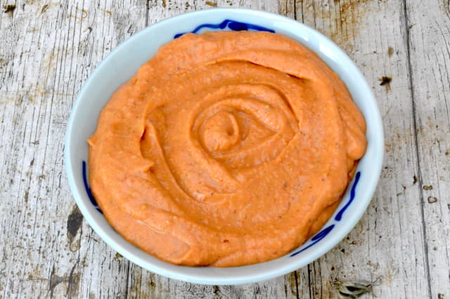 A bowl of roasted tomato and white bean dip.