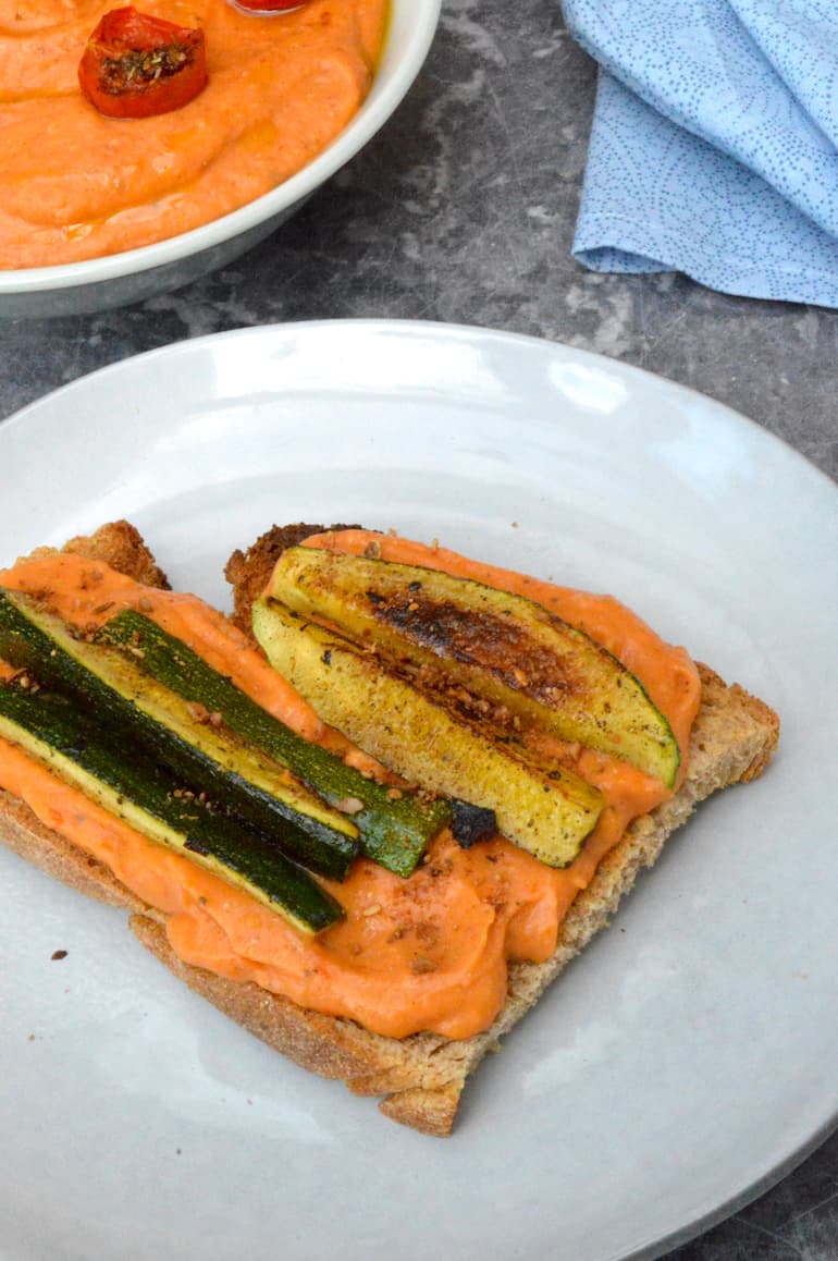 Roasted tomato and white been dip on toast topped with fried courgettes.