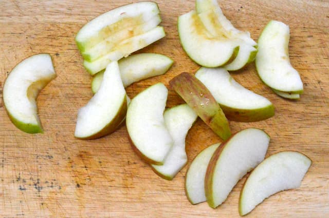 Sliced apples on a chopping board.