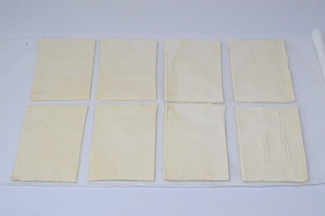 Puff pastry divided into eight rectangles.