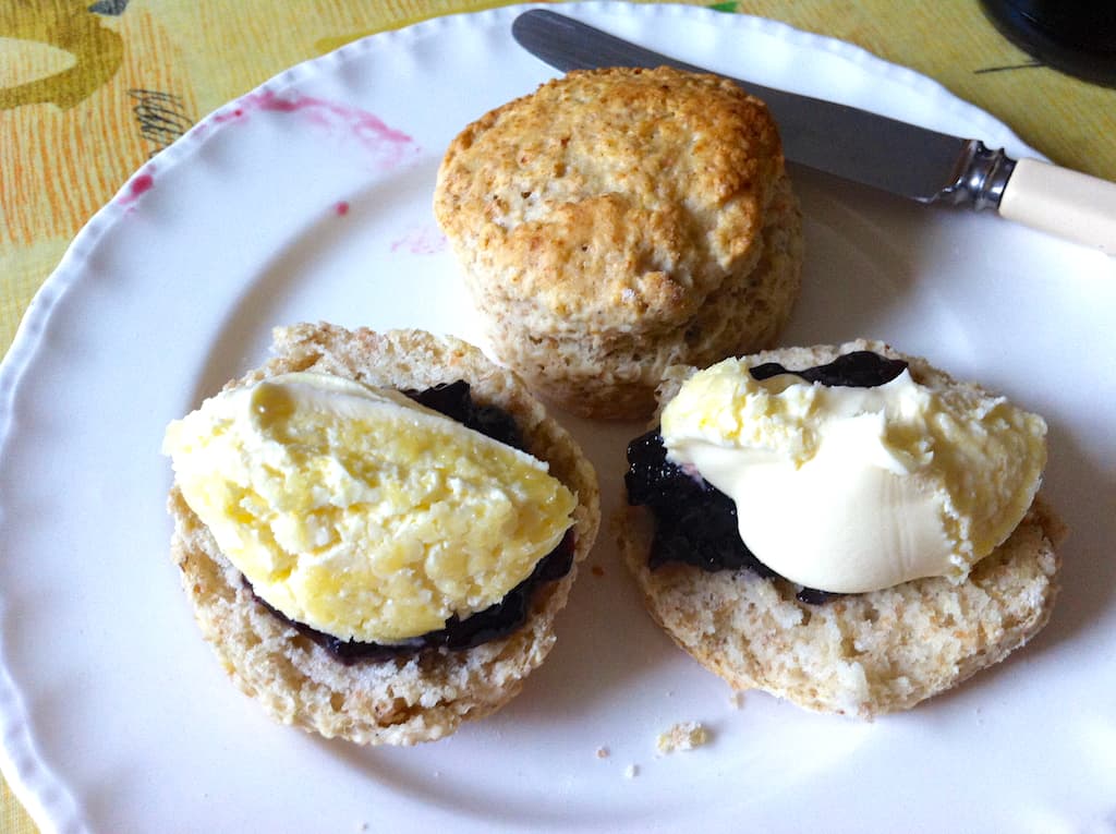 White chocolate and whey Scones loaded with blackcurrant jam and clotted cream.