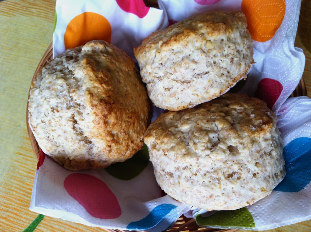 Three white chocolate and whey scones in a basket.