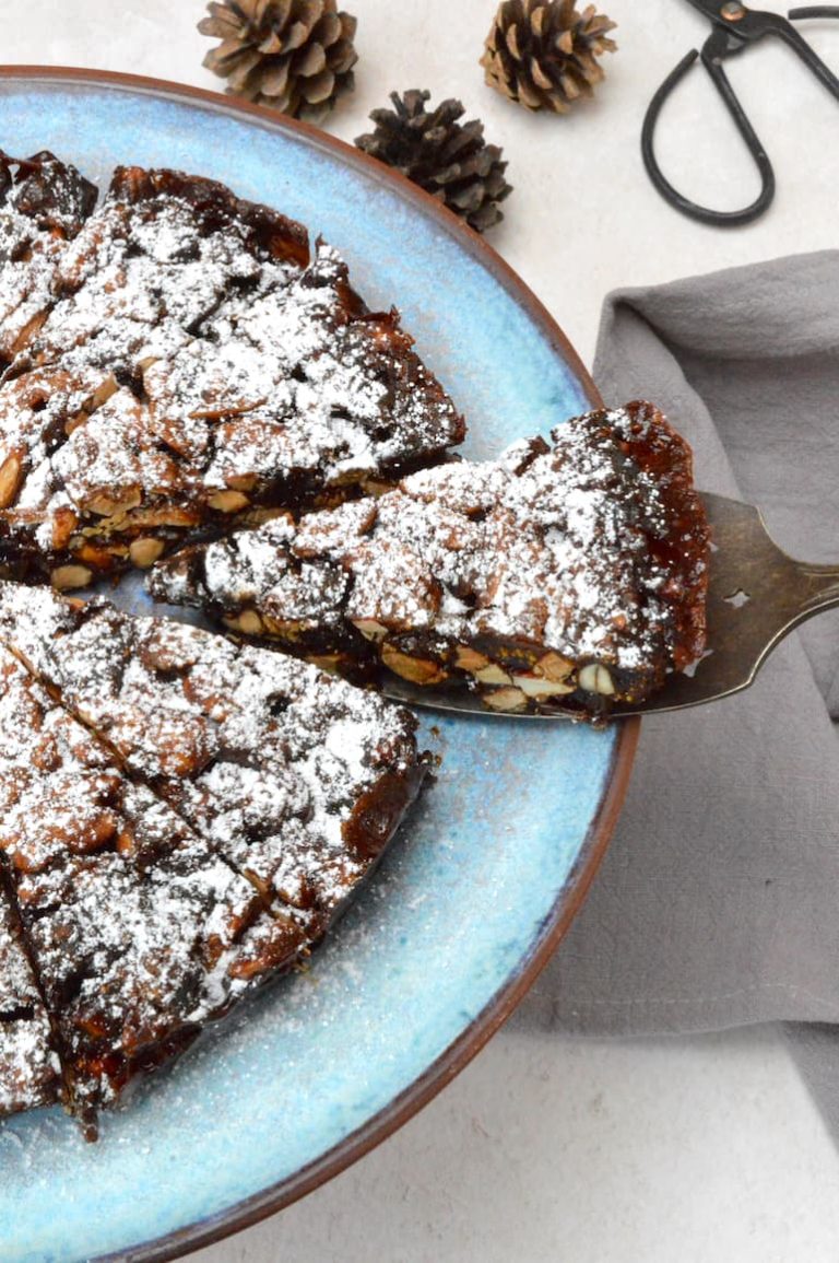 A slice of panforte being removed from the rest.