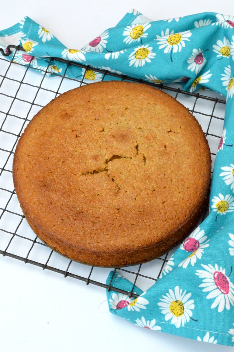 Simple lemon curd cake cooling on wire rack.
