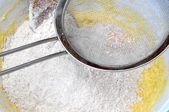 Sieve with a little bran left in sitting on mixing bowl.