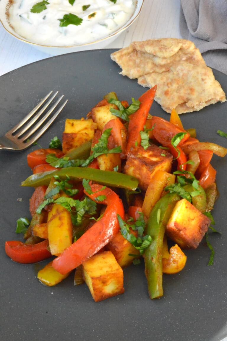 Easy homemade paneer jalfrezi on plate with fork and bread.