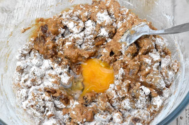 Egg broken into middle of cake batter.