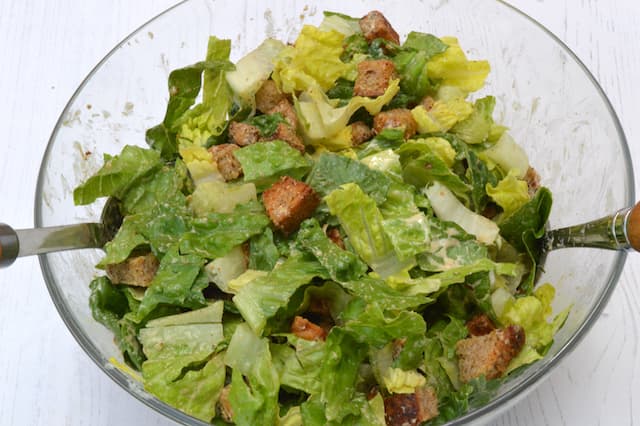Salad tossed with dressing.