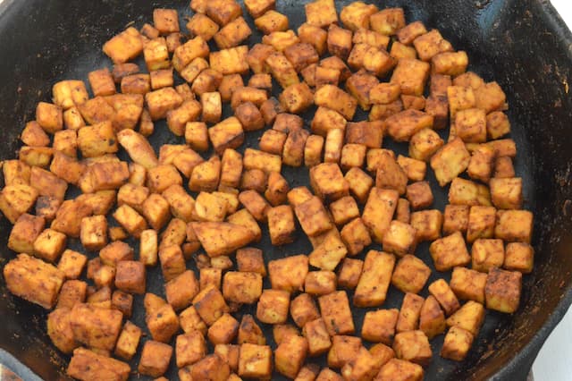 Tempeh frying in skillet.