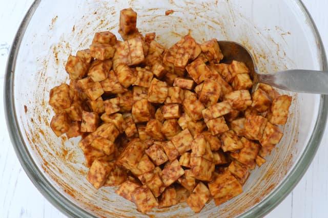 Tempeh cubes soaking up marinade.