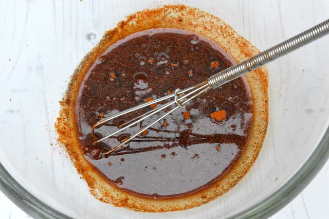 Marinade in bowl with whisk.