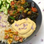 Partial view of aubergine rice bowl with caponata.