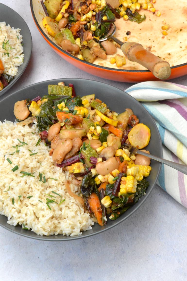 A bowl of brown rice with butter beans, courgettes and sweetcorn.
