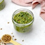 A jar of homemade Thai green curry paste without lid.