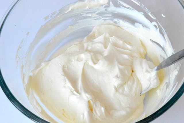 Yoghurt and cream mixed together in bowl.