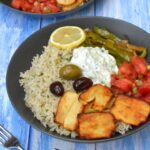 Greek rice nourish bowl with partial view of a second one.