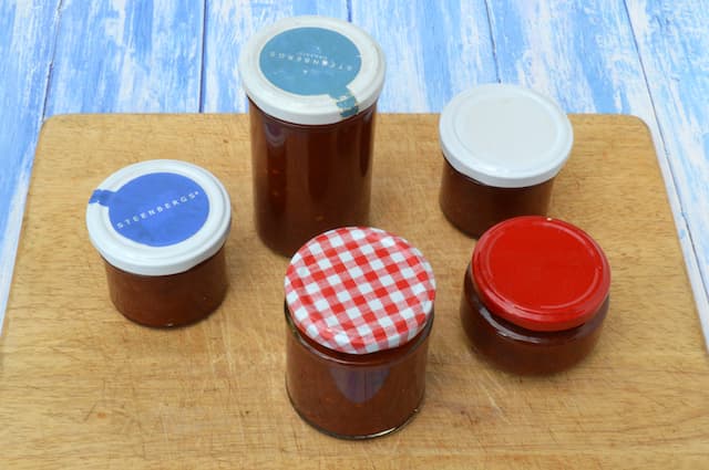Five sealed jars of chilli and tomato chutney.