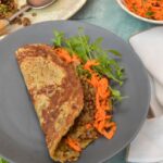 Simple vegan lentil mince in folded flatbread with carrot salad and chickweed.