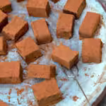 Close up of cocoa dusted coffee truffles on plate.