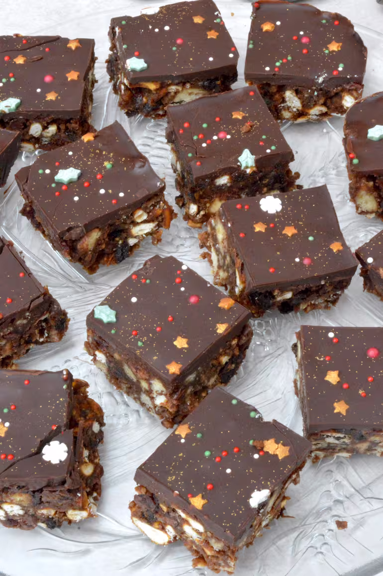 Squares of Christmas tiffin on a glass plate.